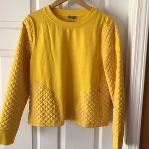 Cozy quilted crew neck pullover size M in brilliant gold color. Two zip pockets
